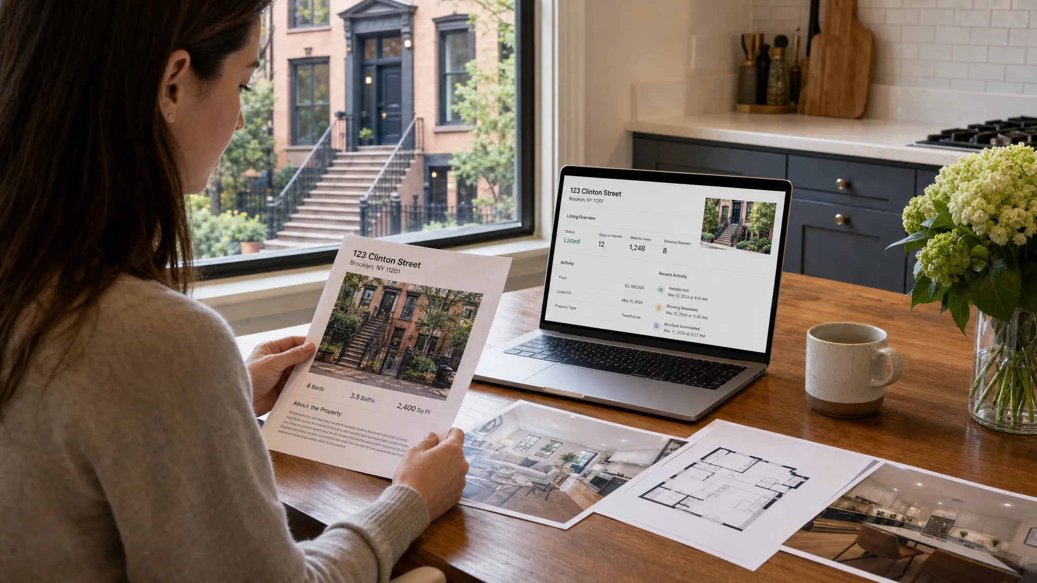 A New York home seller reviewing printed property details, listing photos, and a laptop showing a real estate listing dashboard on a kitchen table, with a townhouse visible through the window.